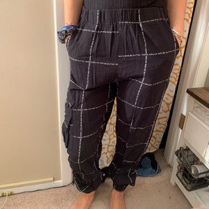 black jogger pants with French writing on them